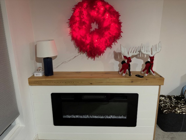 Custom timber mantle built around an electric fireplace